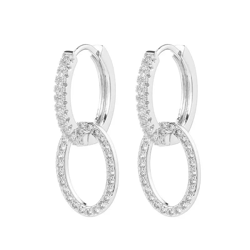 Boucles d'oreilles Ramiart en zircon argenté, style coréen avec anneaux croisés brillants, idéales pour un look sophistiqué et tendance.